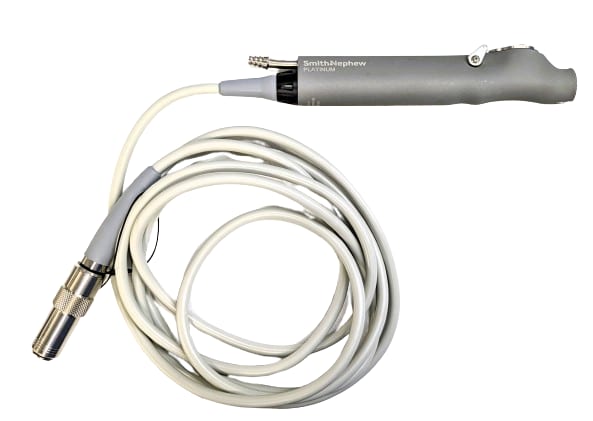 A powered surgical shaver (microdebrider-class) handpiece with a coiled drive cable on a white background