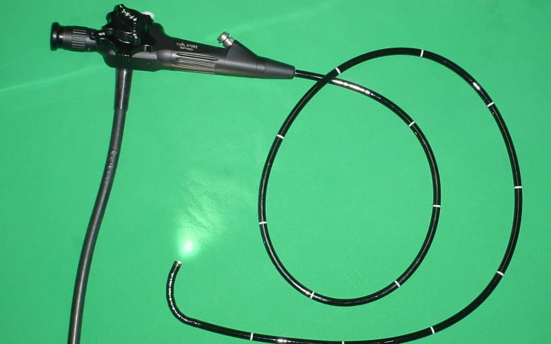 Flexible GI endoscope with a coiled insertion tube and control head