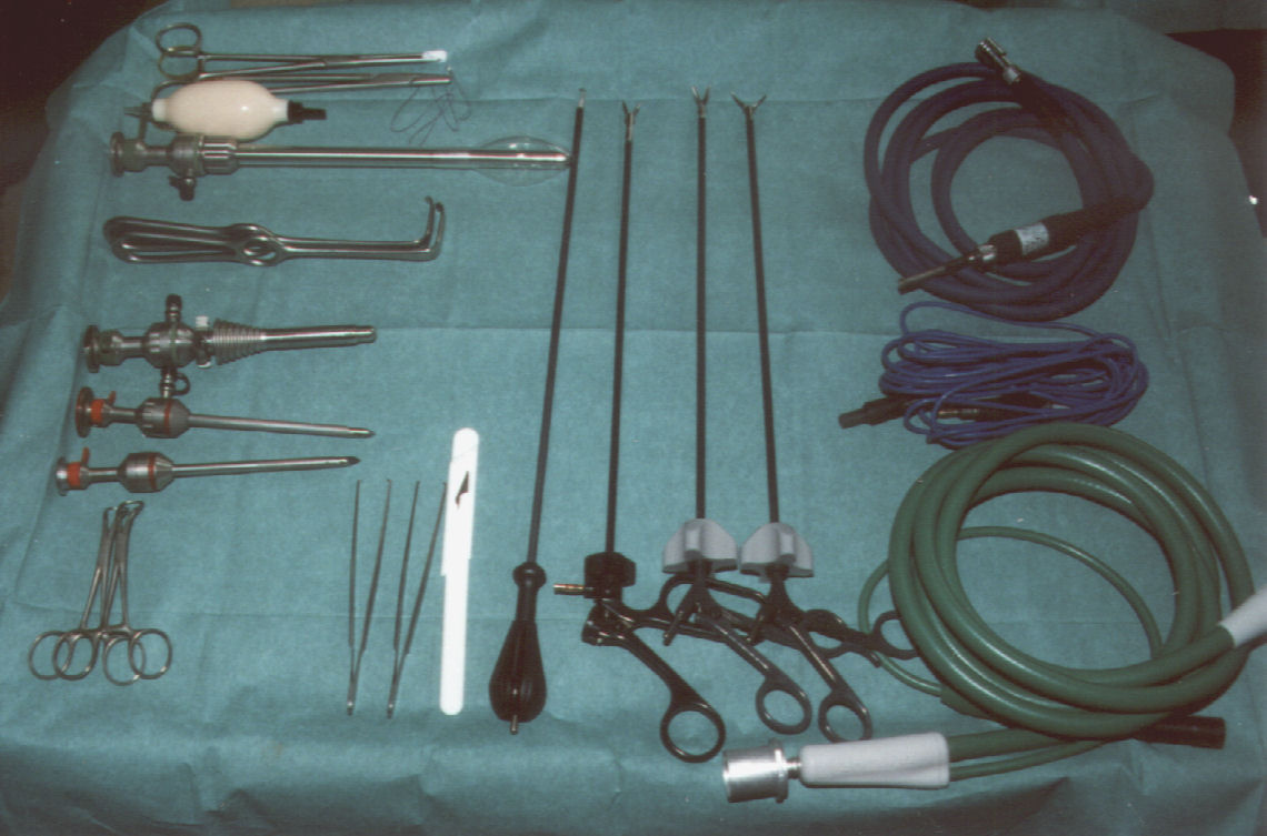 Reusable laparoscopic trocars and cannulas with light-source and camera cables staged on a surgical drape