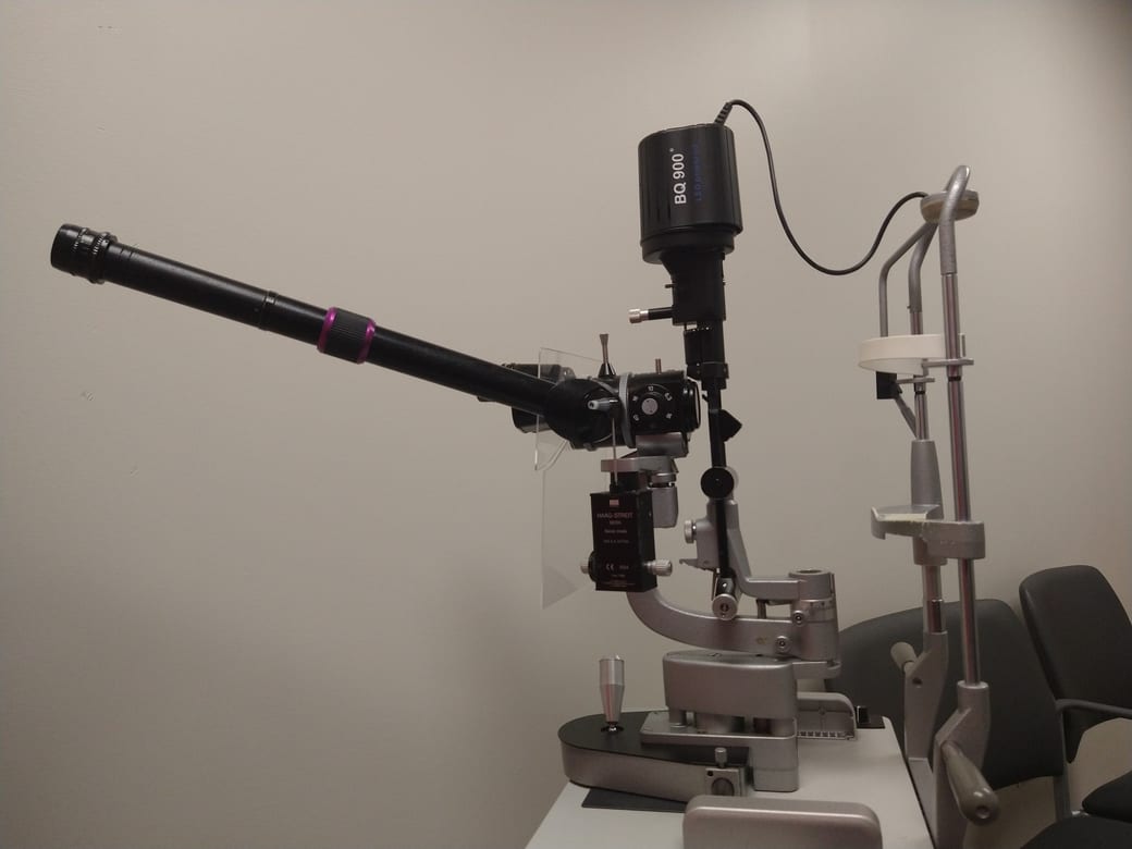 A Haag-Streit BQ 900 ophthalmic slit lamp biomicroscope on its instrument table