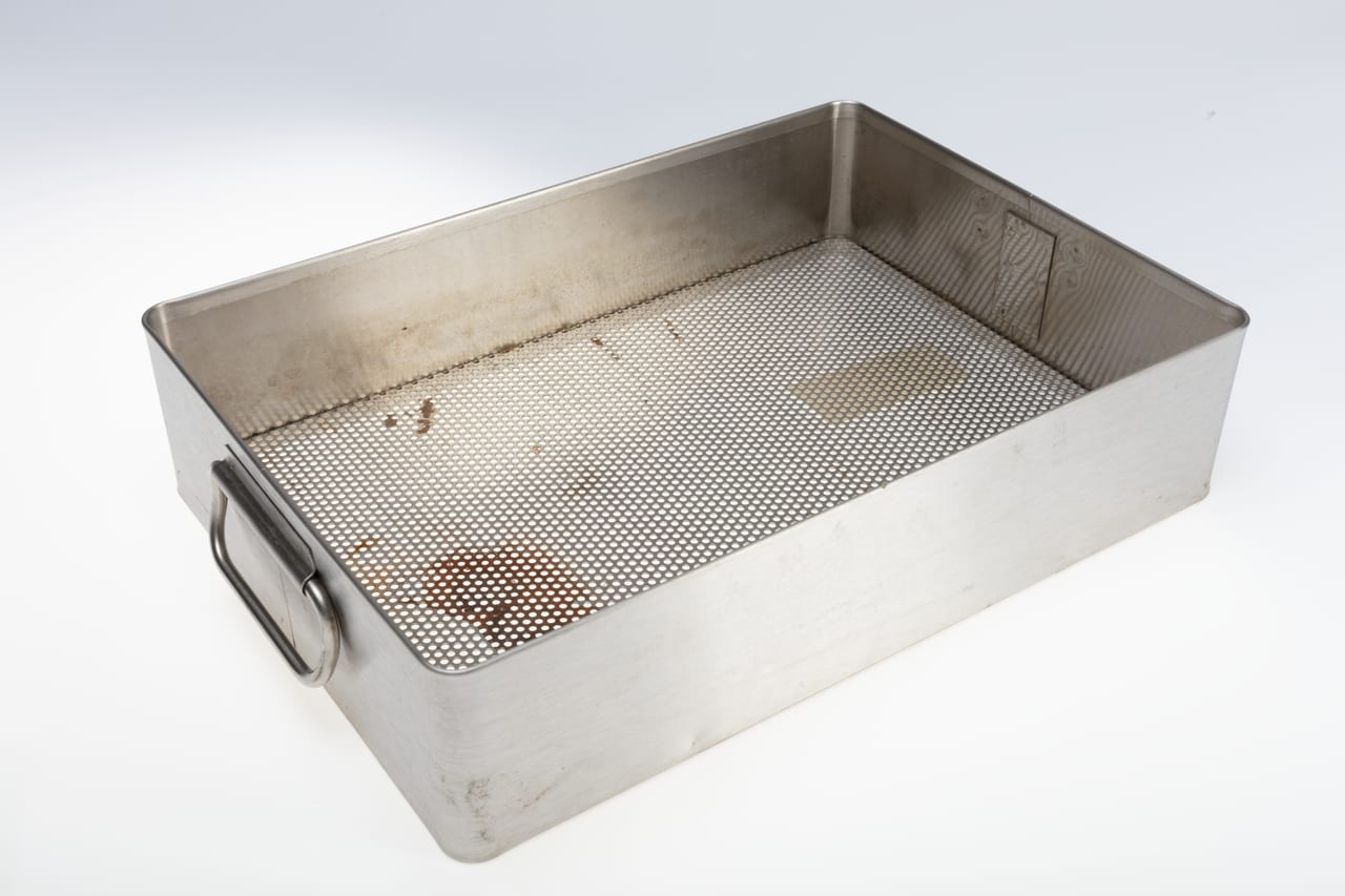 Stainless-steel perforated surgical sterilization tray with a wire handle