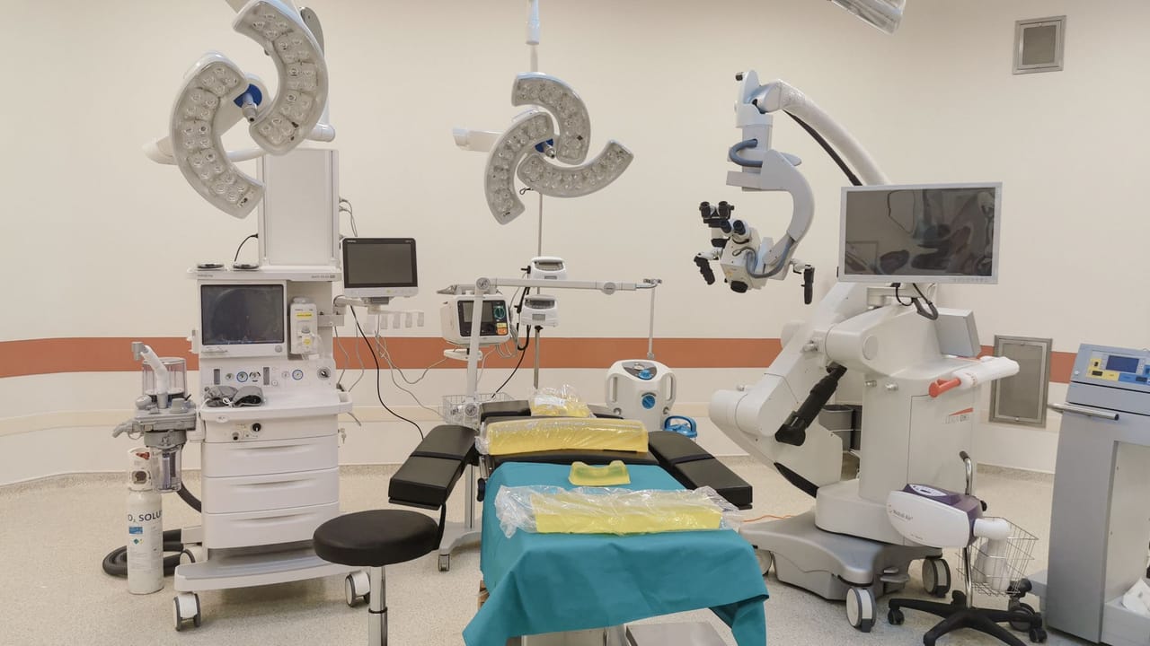 Biomedical technicians inspecting a ventilator to assess its condition and service history.