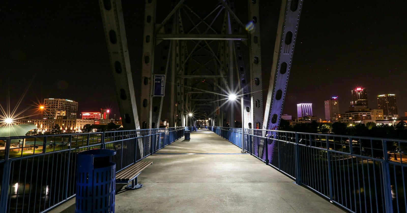 Pedestrian bridge walkway at night with the lit downtown skyline, Little Rock, Arkansas
