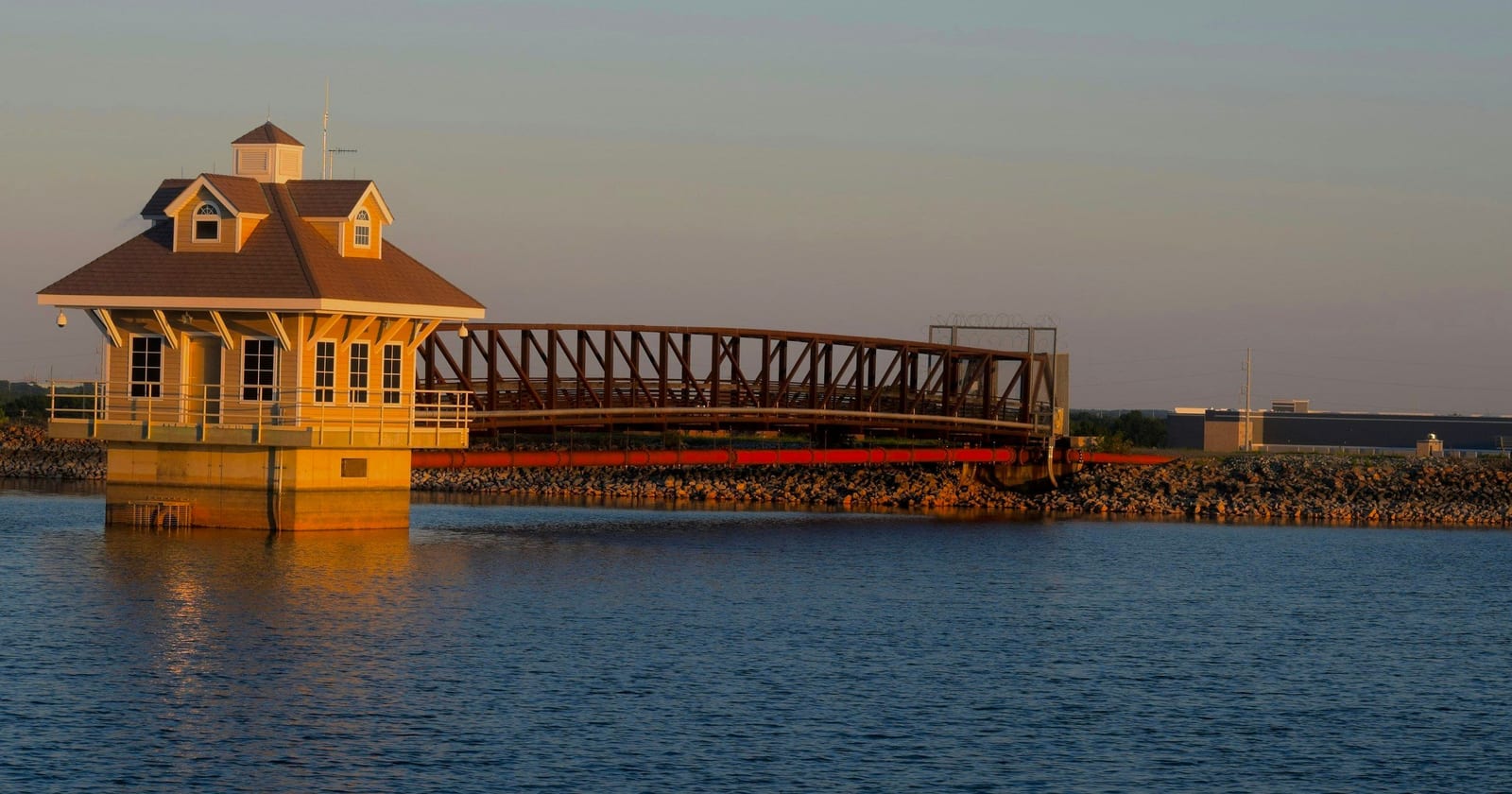 Reservoir gatehouse and truss footbridge in evening light, Newark, Delaware