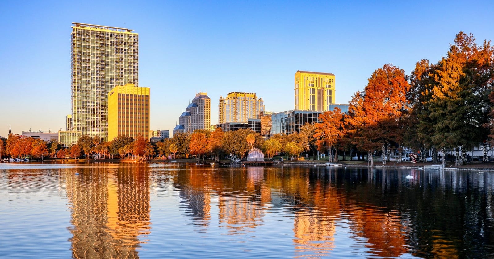 Downtown Orlando towers reflected in Lake Eola at sunrise, Florida