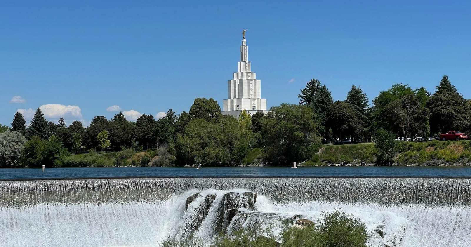 Falls on the Snake River with a temple spire beyond, Idaho Falls, Idaho