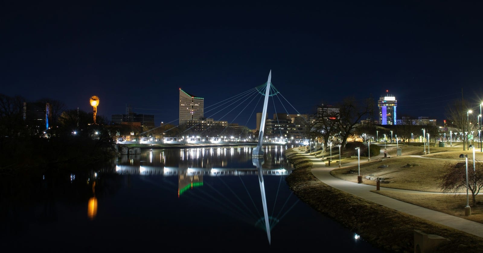 Pedestrian bridge over the Arkansas River and downtown Wichita at night, Kansas