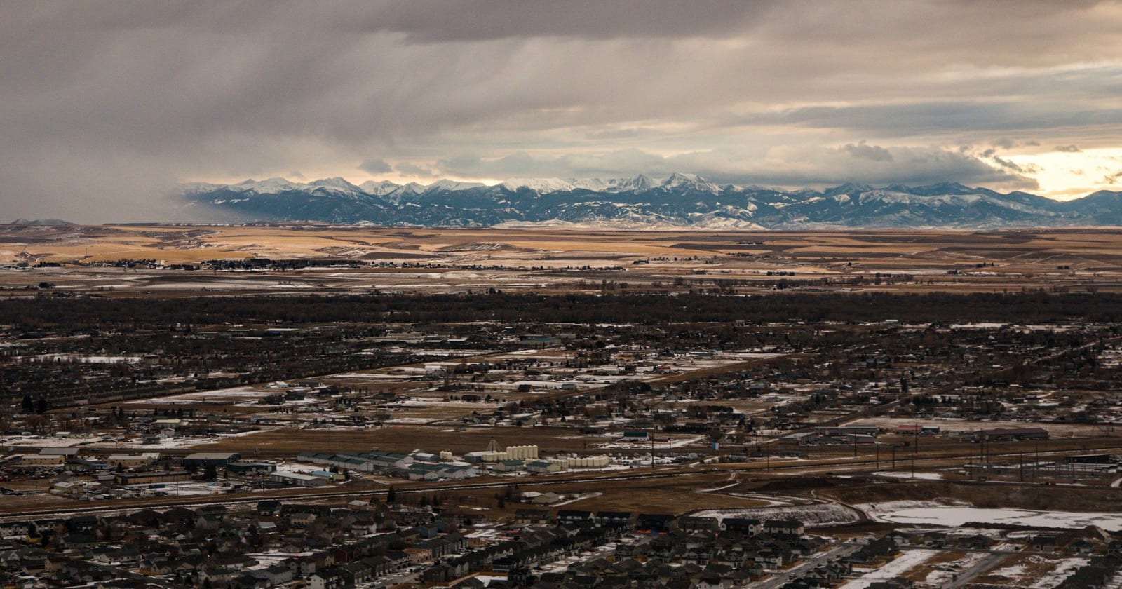 Aerial view across Bozeman toward snow-capped mountains, Montana
