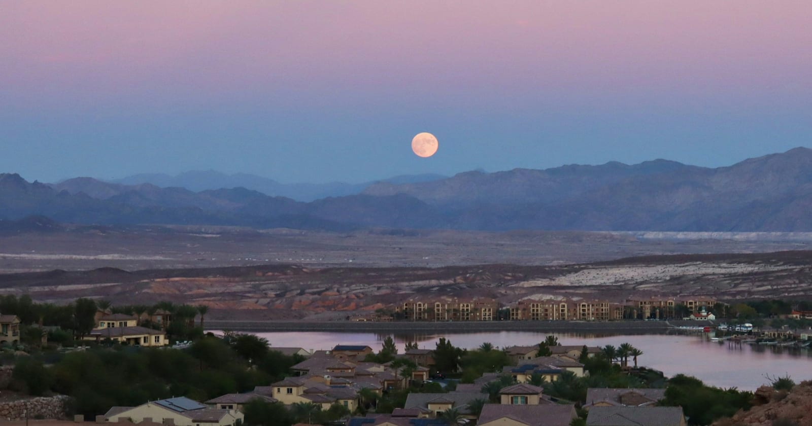 Full moon rising at sunset over Lake Las Vegas, Henderson, Nevada