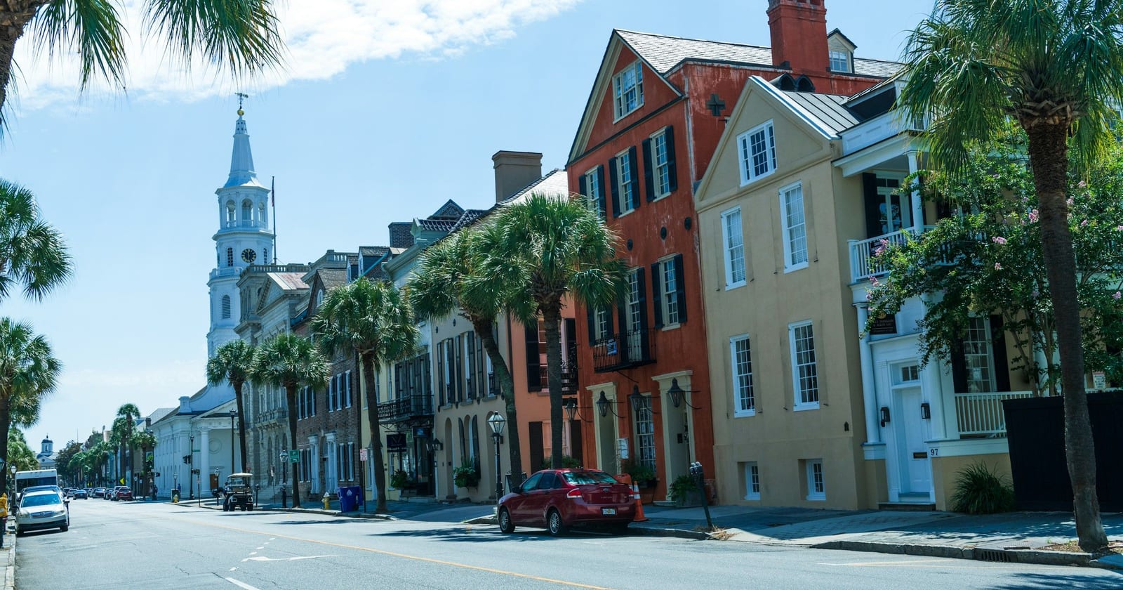 Palmetto-lined historic street leading to a white church steeple, Charleston, South Carolina