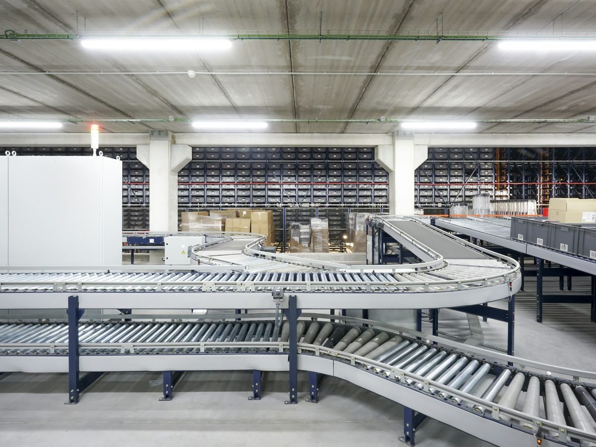 Roller conveyor lines curving across an automated fulfillment floor